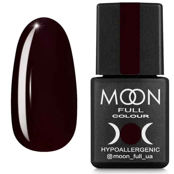 Brown nail polish bottle with a dark brown nail next to it on a white background