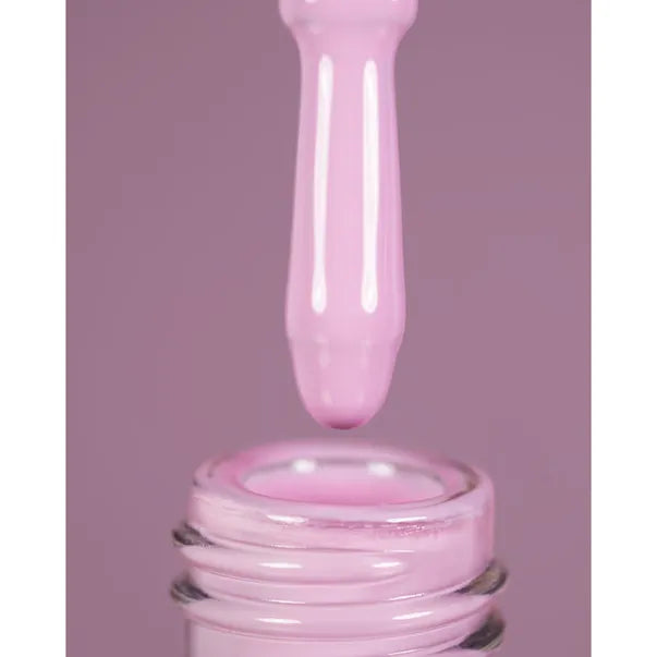 Pink dropper bottle with a droplet of pink liquid against a purple background