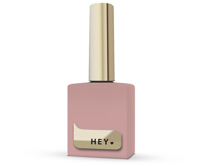 Pink nail polish bottle with gold cap and 'HEY' label on a white background