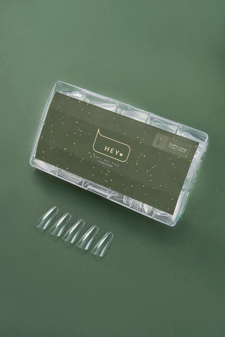 Nail art kit with clear nail tips and a branded case HEYLOVEon a green background