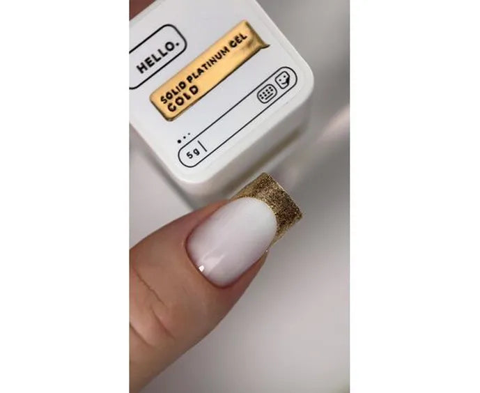 Solid platinum gel packaging with a gold-colored gel stick held by a hand.