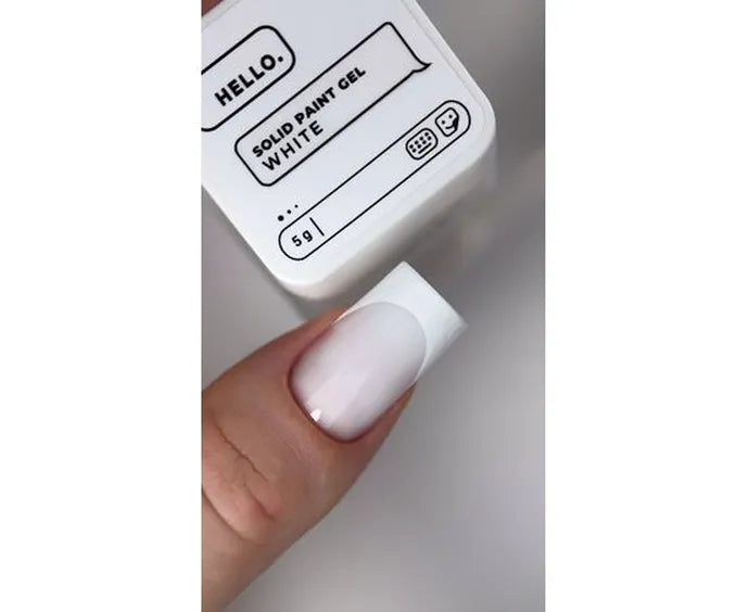 Solid HEYLOVE paint gel container labeled 'White' held by a hand with white nail polish.