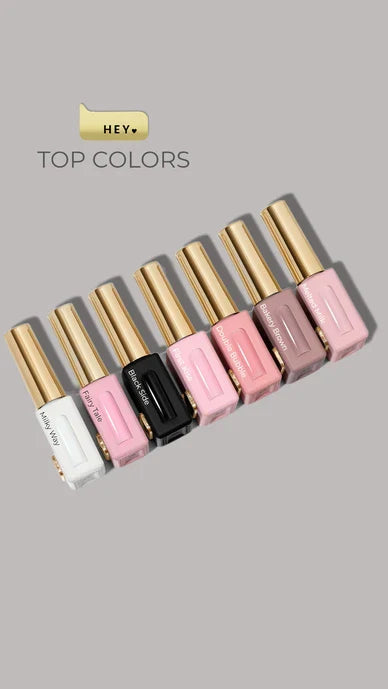 Set of gloss tubes with gold caps on a gray background