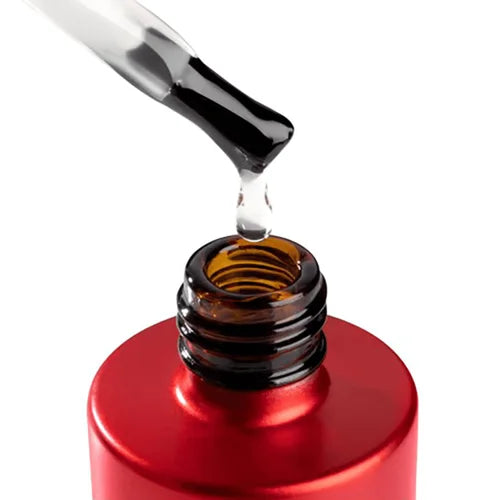 Red dropper bottle with a clear liquid being dispensed onto a white background