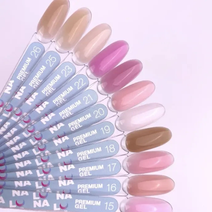 Set of nail polish samples with color swatches on a light pink background