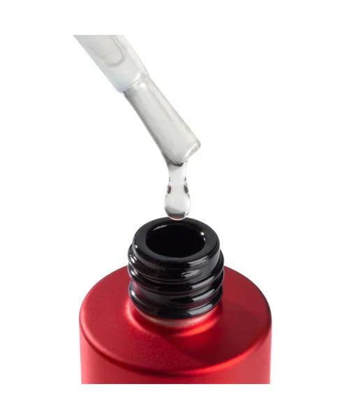 Red container with a black cap being filled with clear liquid using a dropper.