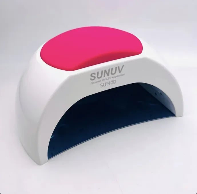 Sun UV nail lamp with pink top on a white background