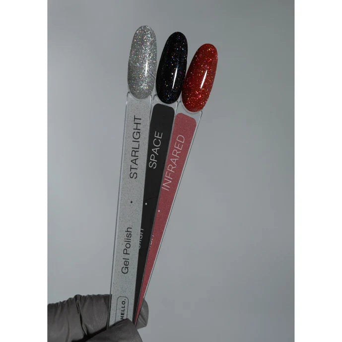Three nail polish samples labeled 'Starlight', 'Space', and 'Infrared' held by a gloved hand against a gray background.