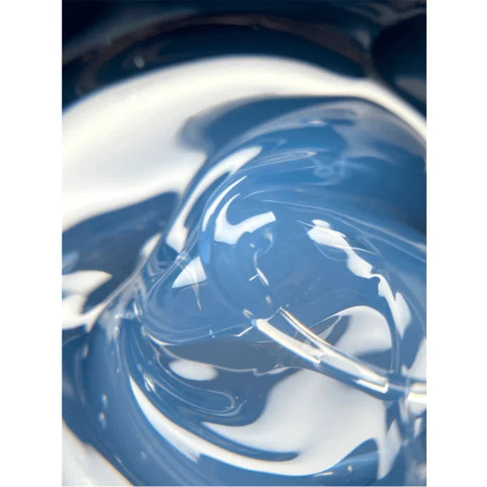 Close-up of swirling blue and white liquid in a container.