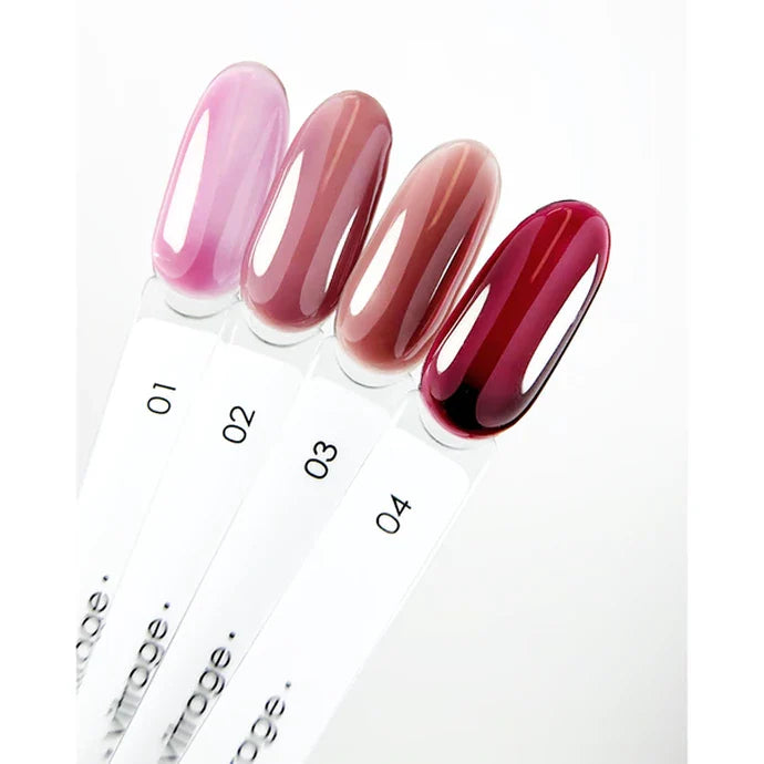 Four lip gloss samples with gradient colors on a white background